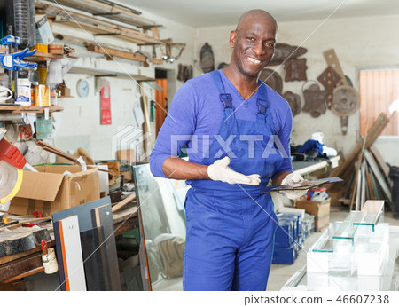 Confident glazier in glass workroom 46607238