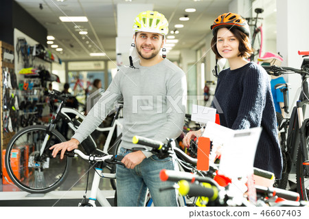 couple in helmet standing with cycle couple in helmet standing with cycle 46607403