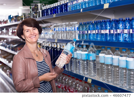 woman selecting water at the store. 46607477
