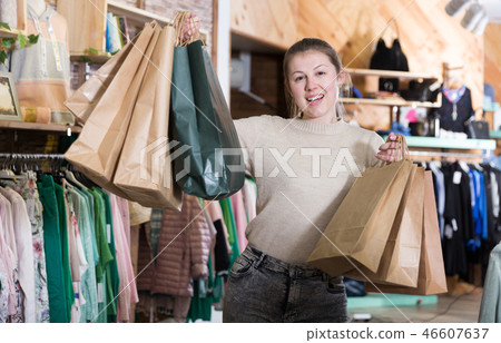 Young woman is standing satisfied after shopping Young woman is standing satisfied after shopping 46607637