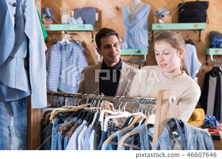Smiling woman and man are choosing variety clothes on hanger Smiling woman and man are choosing variety clothes on hanger 46607646