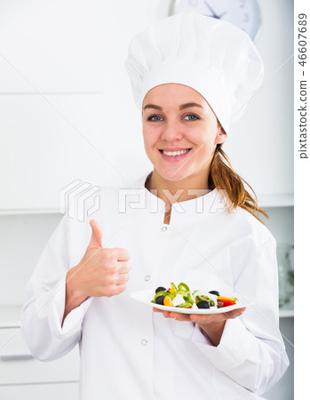 Girl cook shows plate of salad 46607689