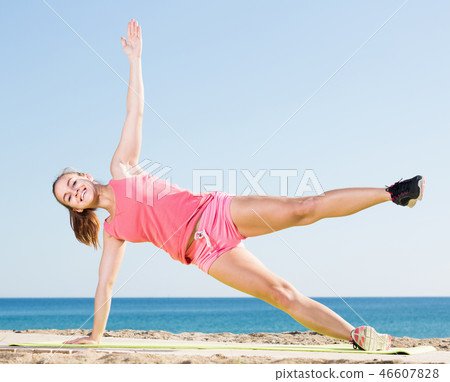 Young woman training at sea beach outdoor 46607828