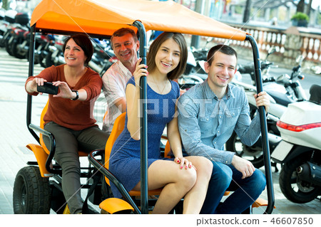 Family of four sitting in grand tour electric Family of four sitting in grand tour electric 46607850