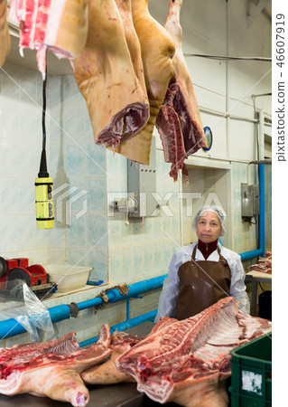 Workwoman cutting meat 46607919