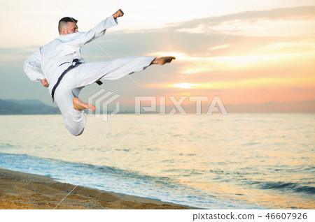 Guy doing karate poses at sunset sea shore Guy doing karate poses at sunset sea shore 46607926
