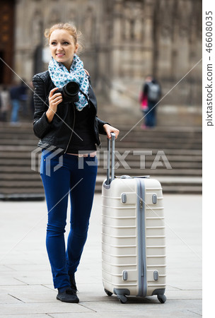 Young female traveller with camera 46608035