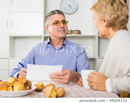 couple at table attentively study documents couple at table attentively study documents 46608139