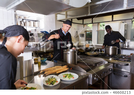 Chef with team preparing food Chef with team preparing food 46608213
