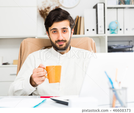 Office worker holding orange cup Office worker holding orange cup 46608373