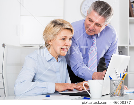 Mature man helping his colleague 46608377