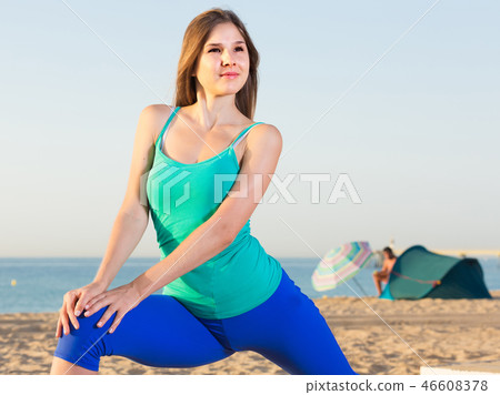 Portrait of sportswoman which is doing excercises for warm-up Portrait of sportswoman which is doing excercises for warm-up 46608378