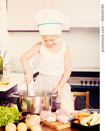 Girl cooking food at domestic kitchen 46608380