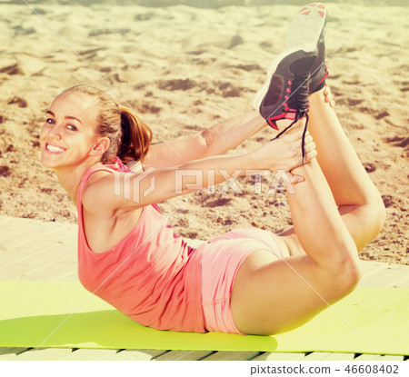 Happy girl training at sea beach outdoors Happy girl training at sea beach outdoors 46608402