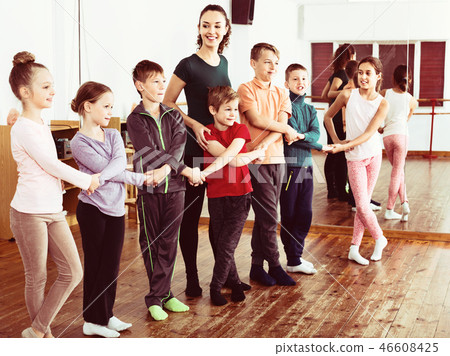 Boys and girls studying folk dance in studio Boys and girls studying folk dance in studio 46608425