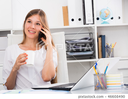 Business woman with phone relaxing at workplace Business woman with phone relaxing at workplace 46608490
