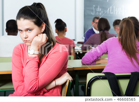 Alone outcasted student being mobbed by other students 46608565