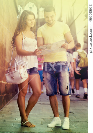 Two friends with map in the street Two friends with map in the street 46608668