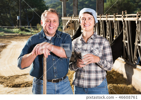 male and female workers posing on cow farm 46608761