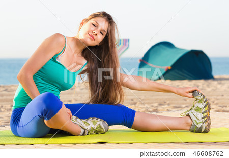 Portrait of sportswoman which is doing excercises on endurance 46608762