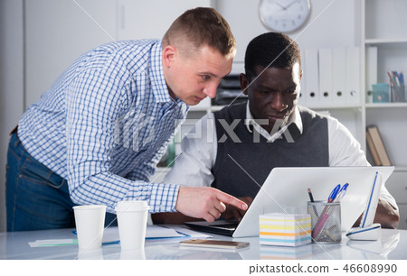 Two interracial businessmen in office working... - Stock Photo [46608990] -  PIXTA