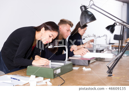 Female architect working on fret saw Female architect working on fret saw 46609135