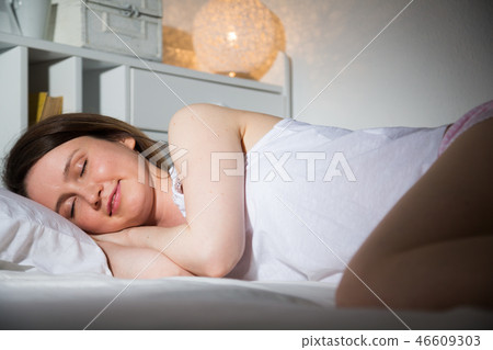 Portrait of relaxed girl in pyjama sleeping in bed in home Portrait of relaxed girl in pyjama sleeping in bed in home 46609303