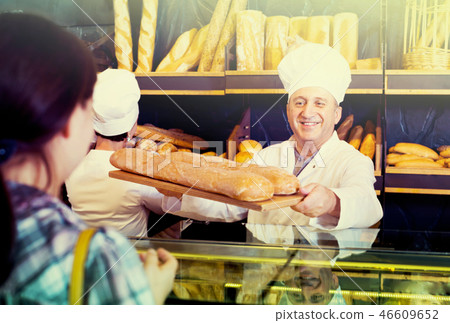female customer buying bread in bakery. 46609652