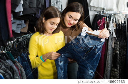 Cheerful people are buying trendy colorful trousers 46609683