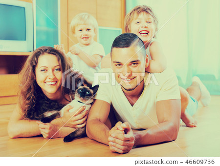 Parents and two daughters with Siamese Parents and two daughters with Siamese 46609736