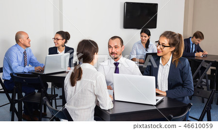 Coworkers working effectively on business project together Coworkers working effectively on business project together 46610059