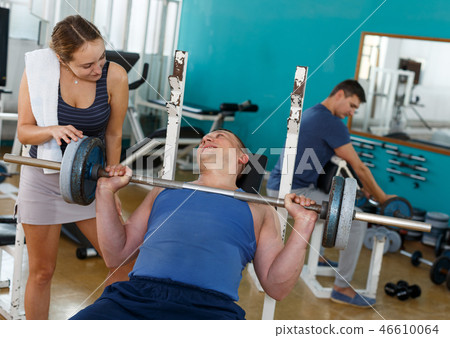 Man in sportswear doing bench press Man in sportswear doing bench press 46610064