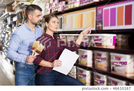 couple is choosing color for paint with brushes 46610167