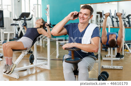 Man in sportswear using his mobile phone Man in sportswear using his mobile phone 46610170