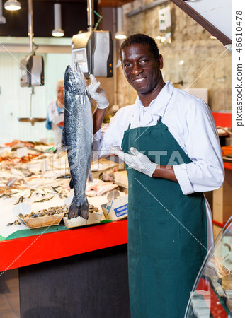Salesman offering fresh fish Salesman offering fresh fish 46610478