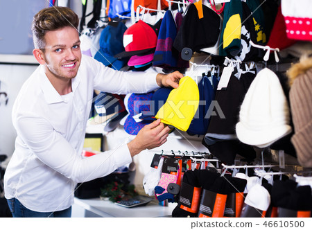 Man choosing new knit cap Man choosing new knit cap 46610500
