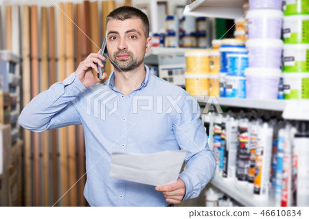designer is choosing paint and talking by phone 46610834