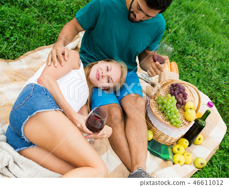 Young female is resting on the lap of man 46611012