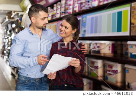 couple is choosing color for paint with shop list couple is choosing color for paint with shop list 46611038