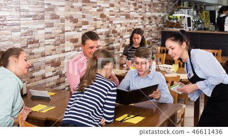 Happy parents with children are giving order to cheerful waitress 46611436