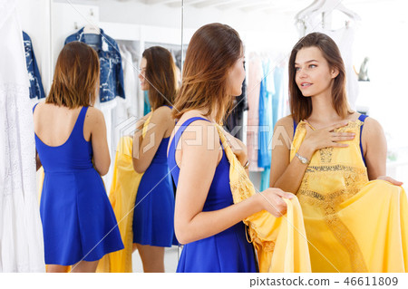 Girl trying new dress in front of mirror Girl trying new dress in front of mirror 46611809