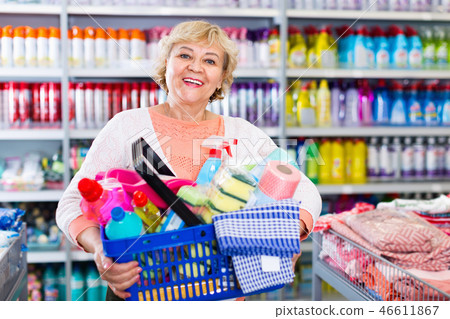 Woman consumer with household chemical products in basket for cleaning 46611867