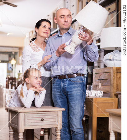 Family choosing lamp in store Family choosing lamp in store 46612102
