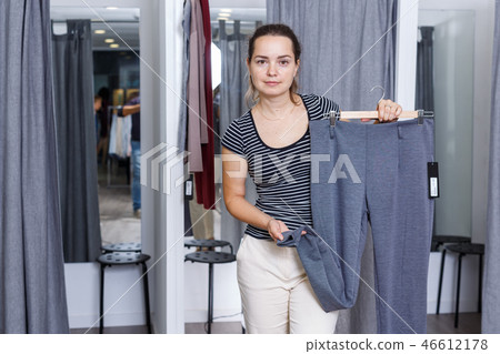Woman trying clothes in fitting room 46612178