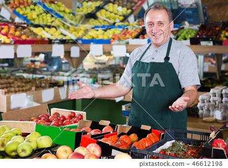 Portrait of glad man seller in supermarket 46612198