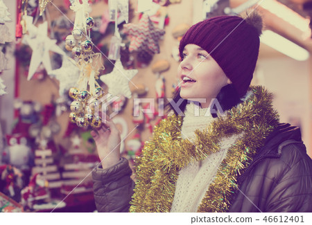 Happy young girl shopping at festive fair Happy young girl shopping at festive fair 46612401