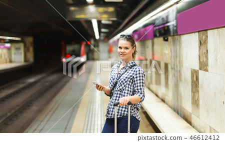 Portrait of girl with suitcase waiting for train Portrait of girl with suitcase waiting for train 46612412