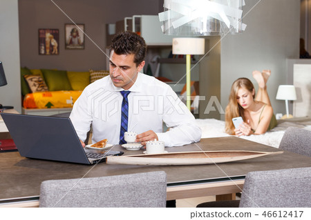 Man drinking coffee and working with laptop 46612417