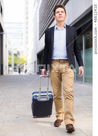 Portrait of cheerful male standing with bag Portrait of cheerful male standing with bag 46612418