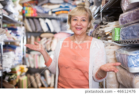 female housewife choosing textile in the store 46612476